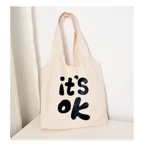Canvas tote bag detail view, casual minimalist style with bold letter print design.