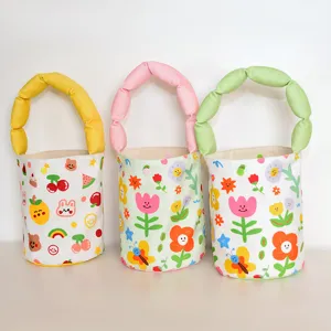 Cute canvas bucket bag with fluffy padded handle and sweet cartoon flower print for daily use.
