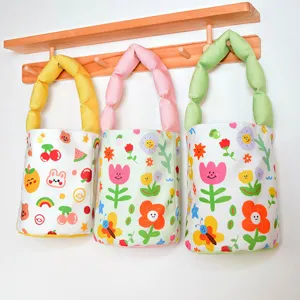 Cute floral canvas bucket bag with padded handle, stylish handheld tote for daily women.