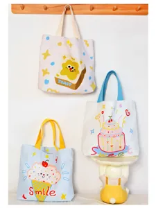 Detailed view of cute canvas tote bag with playful cartoon toast print for casual daily wear.