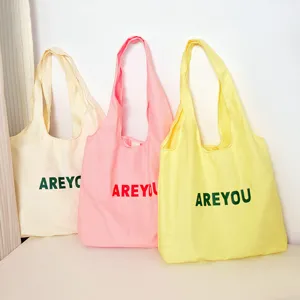Canvas tote bag detail view, casual large capacity multi-color shoulder bag design.
