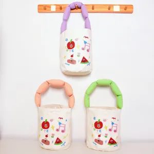 Canvas bucket tote bag featuring cute cartoon prints and soft colorful handles for summer fashion.