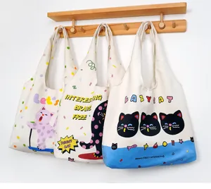 Canvas tote bag with cute cartoon cat print, large capacity daily shoulder bag for students.
