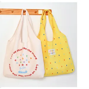 Cute canvas tote bag with stylish print, casual large capacity shoulder bag for daily use.