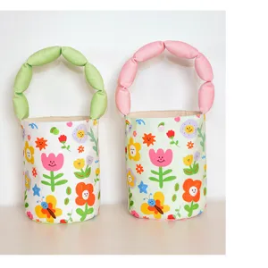 Cute floral canvas bucket bag detail, featuring puffed strap and vibrant colorful cartoon prints.
