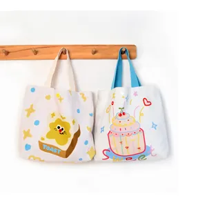 Cute canvas tote bag with toast and cake cartoon prints, perfect for daily casual use.