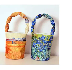 Art print padded bucket bag handle detail, canvas fashion shoulder handbag detail view.