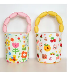 Cute cartoon printed canvas bucket bag with soft stuffed cotton puffy handle for daily use.