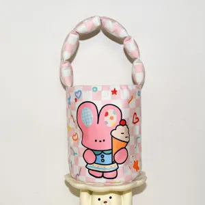 Pink checkered bucket bag detail featuring a cute cartoon rabbit and ice cream graphic handle.