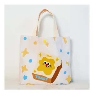 Cute cartoon toast canvas handbag, casual versatile tote bag for women and students in summer.