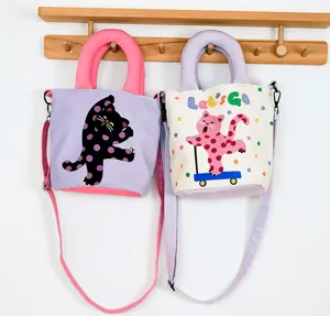 Detailed shot of cute cat polka dot bucket bags hanging on a wooden rack, velvet material.