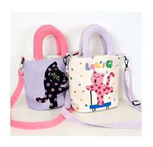 Canvas bucket bag featuring cute polka dot cat design and top handle for casual daily wear.