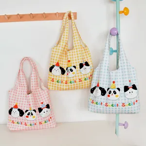 Detailed view of cute plaid canvas tote bags with sweet cartoon animal prints and large capacity.