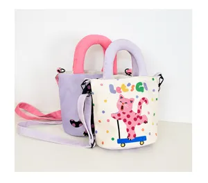 Cute canvas bucket bag detail featuring a playful polka dot cat print and stylish handles.
