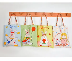 Cute cartoon canvas tote bag with rabbit and fruit prints, lightweight casual handbag for daily use.