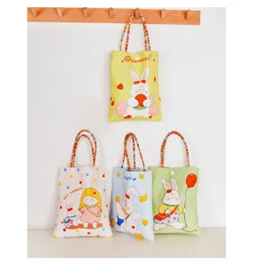 Detailed view of cute cartoon printed canvas tote bags featuring adorable rabbit and girl patterns.