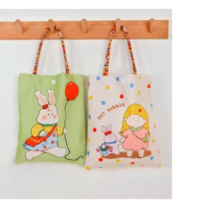 Canvas tote bag with cute cartoon rabbit print, casual small handbag with woven handles.