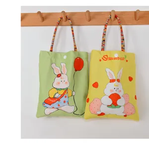 Cute cartoon rabbit printed canvas handbag, stylish casual tote bag for women and students.