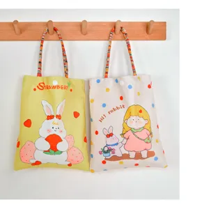 Canvas cartoon print handbag detail shot, featuring cute rabbit and girl design with colorful handles.