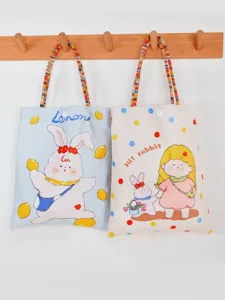 Cute canvas tote bag with cute cartoon rabbit print and stylish colorful braided handles.