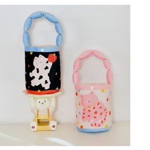 Cute cat print cylinder handbag with puffy handle, soft fabric kids daily tote bag detail.