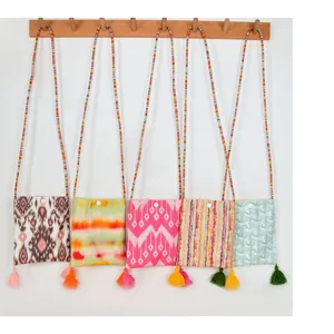 Ethnic style canvas phone crossbody bag with colorful beaded strap and cute tassels.