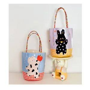 Cute cartoon printed canvas tote bag with beaded handle, ideal kids daily handbag.