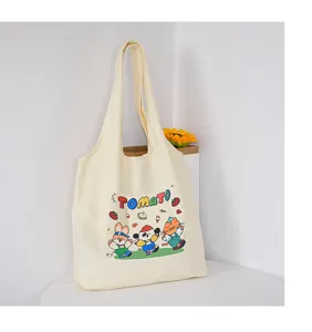 Canvas tote bag with cute tomato cartoon print, casual shoulder bag for students and daily use.