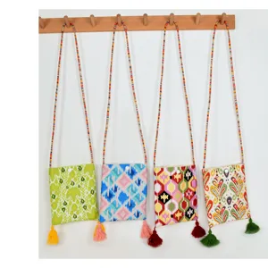 Ethnic style canvas crossbody phone bag with vibrant ethnic patterns, long strap and cute tassels.