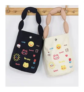 Canvas bucket bag detail with cute letter embroidery and unique bubble handle design.