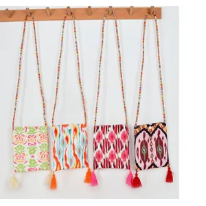 Ethnic style canvas small crossbody phone bag with colorful beaded straps and chic tassels.