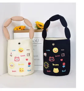 Canvas bucket bag with cute letter embroidery and bubble handle, stylish daily handbag style.