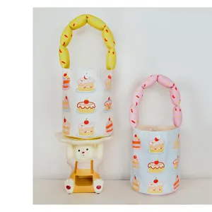 Cute cartoon cake print canvas bucket bag with puffy handle for kids daily casual wear detail view.
