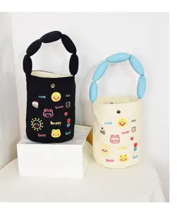 Cute canvas bucket bag with puffy handle and adorable cartoon embroidery, stylish handbag.