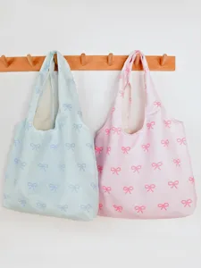 Large capacity canvas tote bag with cute bow print, casual shoulder bag for daily commuting.
