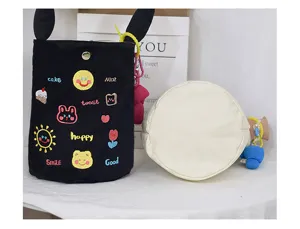 Canvas bucket bag with cute embroidered patches, secure lock closure, and playful rabbit ears.