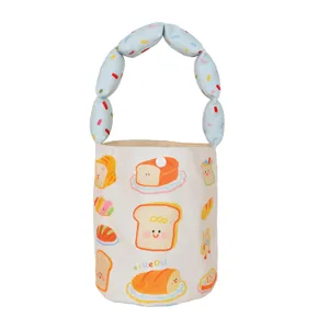 Cute canvas bucket bag with cartoon toast print and bubble handle, versatile kids handbag.