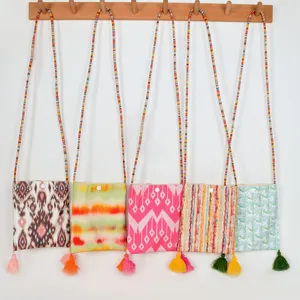 Ethnic style canvas crossbody phone bag with colorful beaded strap and tassel decoration.