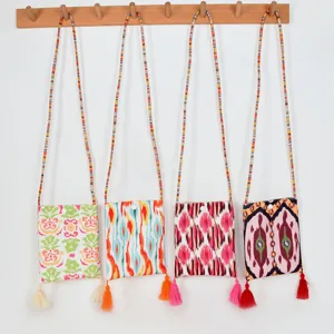 Ethnic style canvas crossbody phone bag with colorful beaded strap and tassel decoration.