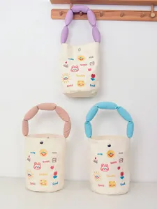 Canvas bucket bag with cute letter embroidery, snap button closure and unique plush handles.