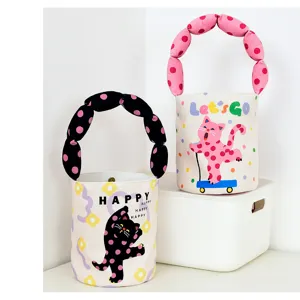 Detailed view of cute canvas bucket bag with bubble handle, funny cat print and letters.