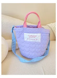 Purple quilted heart tote bag with pink handles and blue crossbody strap for daily use.