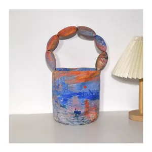 Monet impression style bucket bag with unique padded handle, artistic canvas handbag.