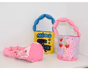 Cute canvas bucket bag with soft padded cloud handle and playful cartoon cat and strawberry prints.