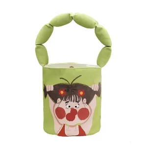 Green canvas bucket bag with cute cartoon print and unique ring handle for women daily use.