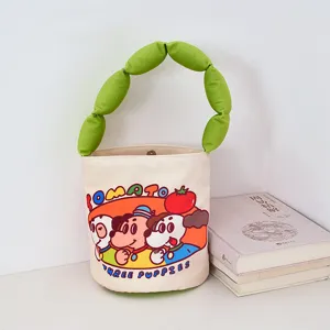 Cute cartoon canvas bucket bag with green stuffed handle, playful puppy tomato print for daily use.