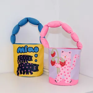 Canvas bucket bag with cute cartoon cat print and padded handle for women and kids.