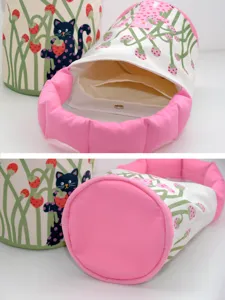 Canvas bucket handbag with cute polka dot cat print and soft pink padded handle for use.