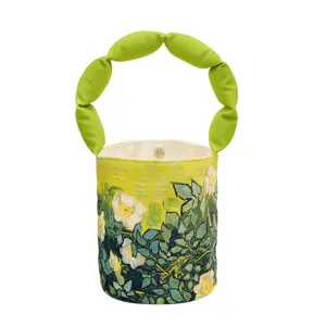 Borsa a secchiello in tela con dipinto di Van Gogh e manico verde sbuffato elegante.