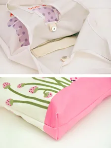 Large capacity canvas shoulder bag with polka dot print and inner zipper pocket.